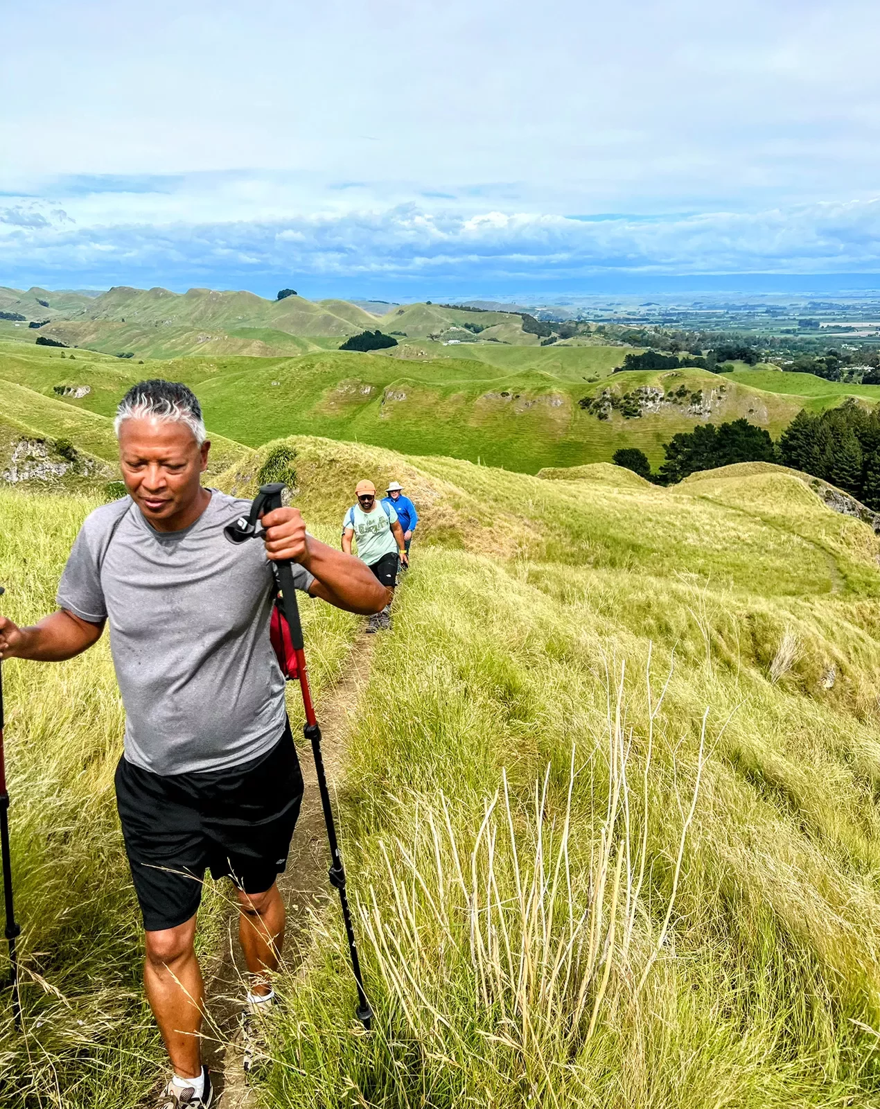 Hiking up a grassy hill in New Zealand