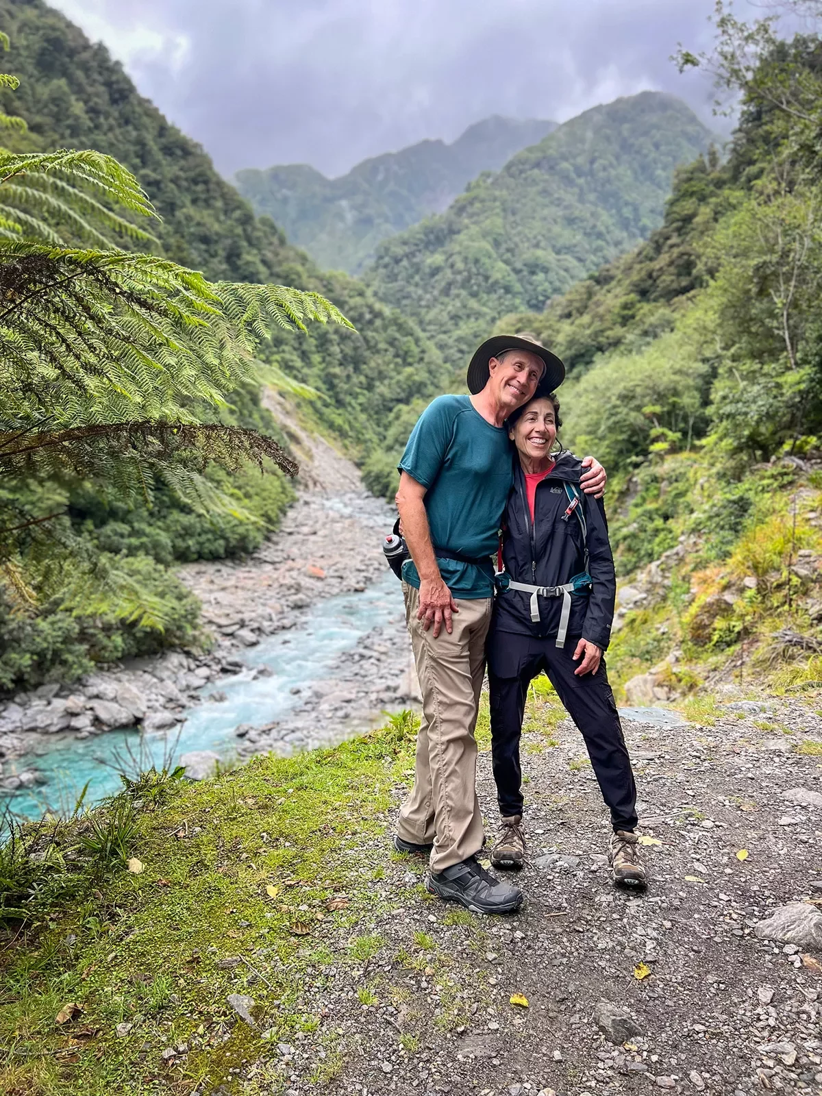 Two people posing next to a stream in New Zealand