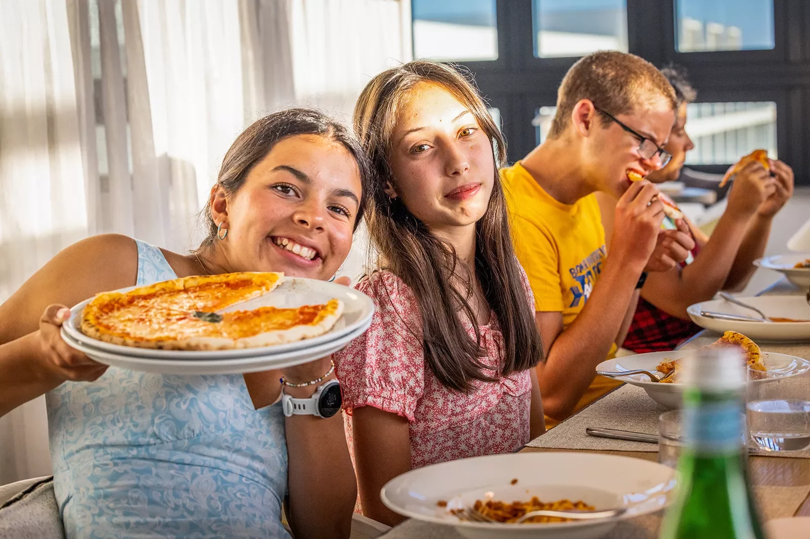 Teenagers eating handmade pizza in Portugal