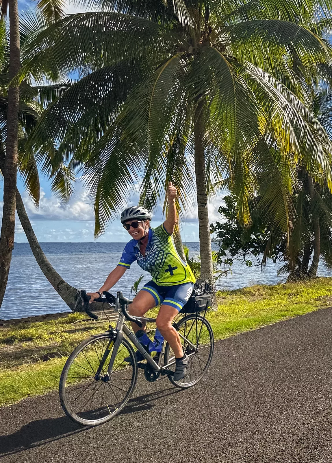 Biking along a palm tree lined shore in Tahiti