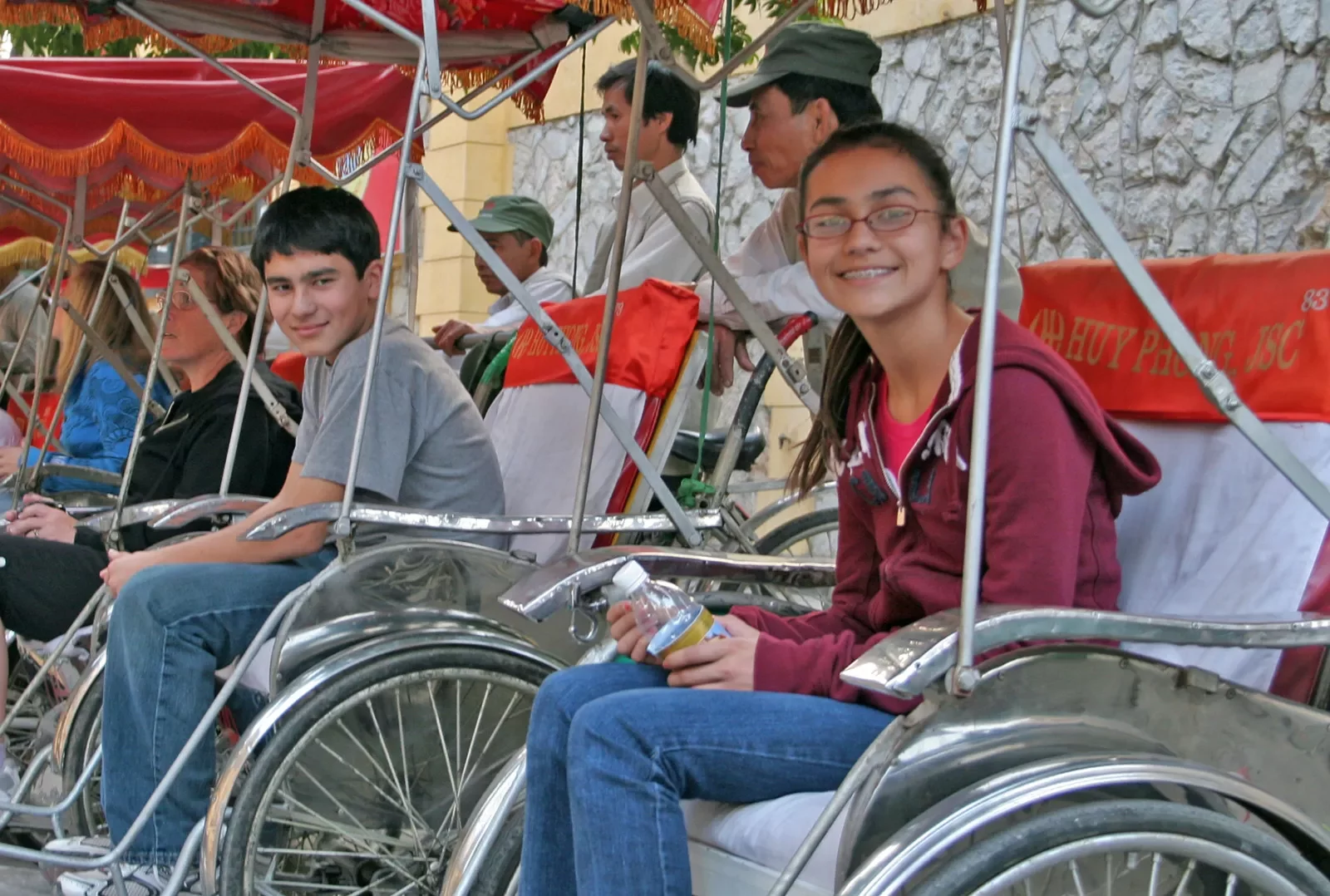Backroads guests sitting in bike pedal carts in Vietnam
