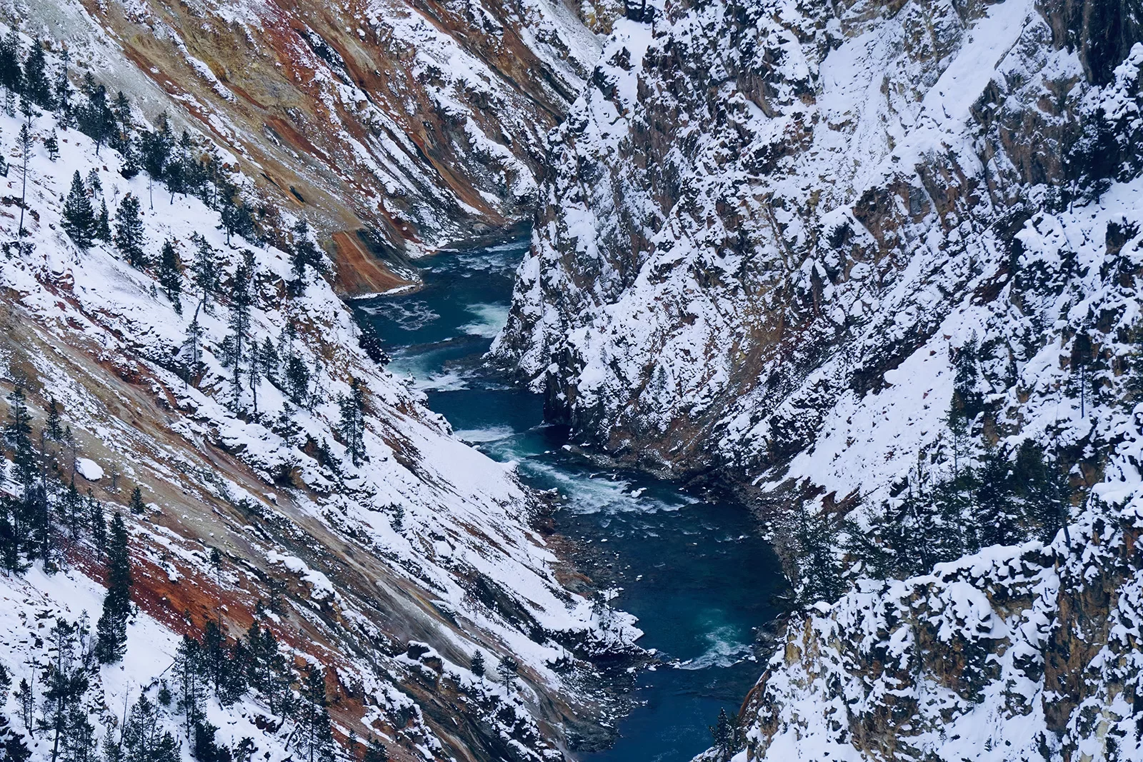 Snow covered mountains and rushing river