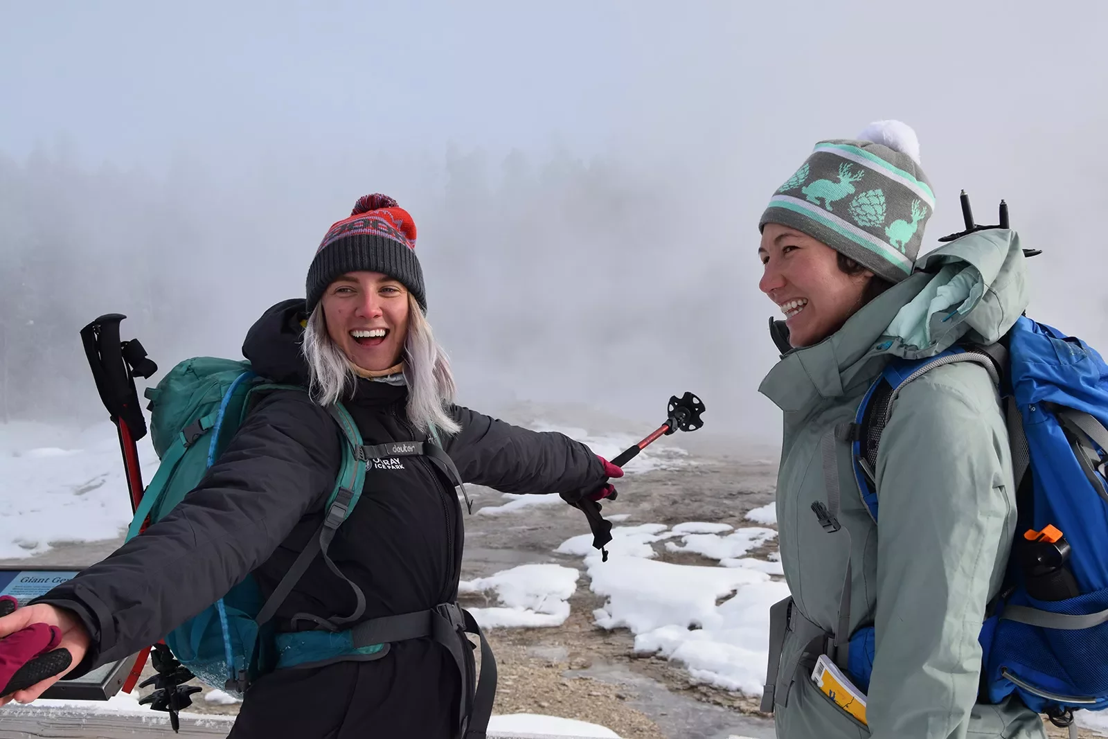 Backroads guests smiling near snowy hot springs