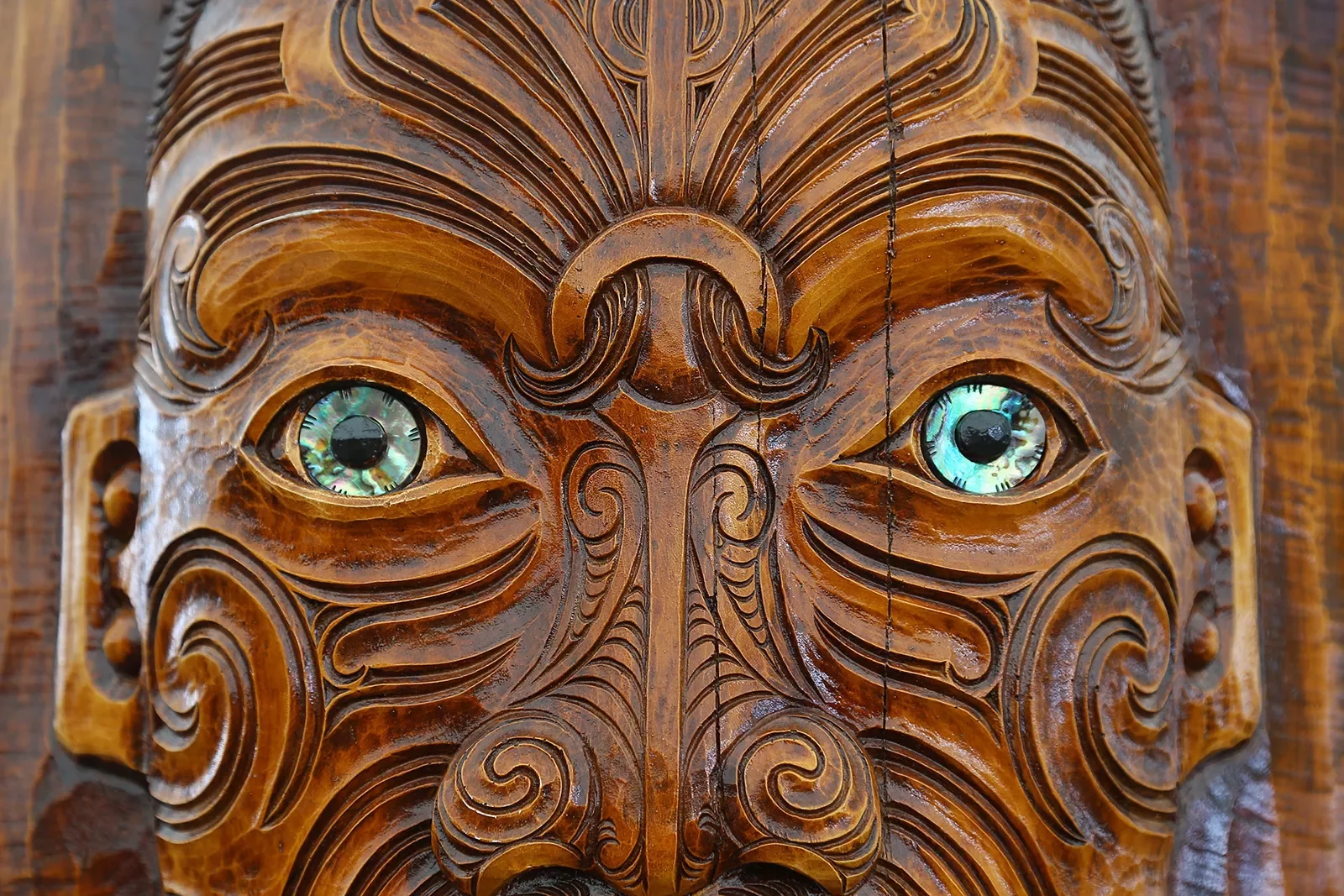 Carved face in Maori style, New Zealand