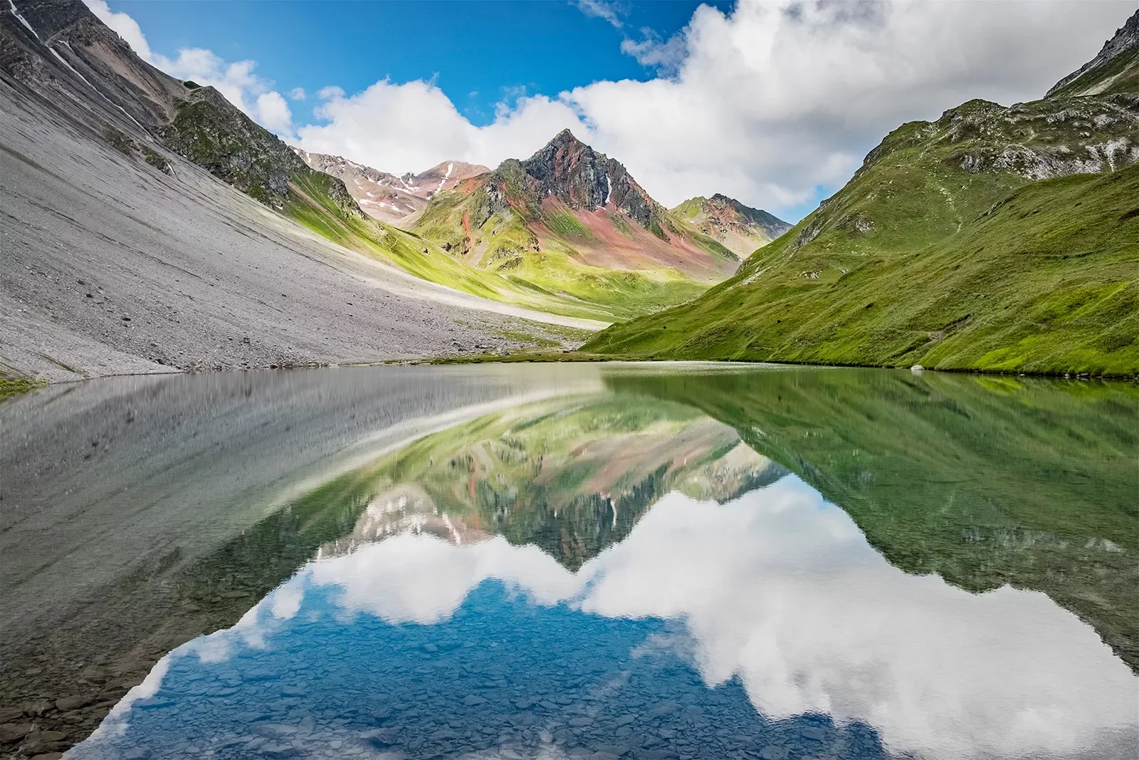 Reflection of mountains in Alps lake.