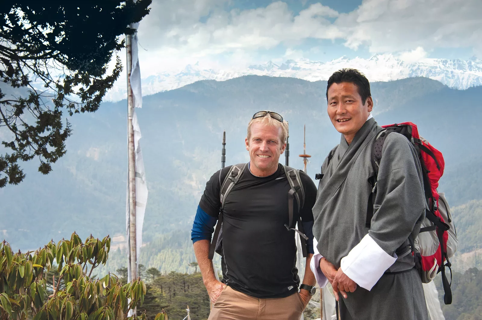 Hiker posing with a local guide in the mountains of Bhutan
