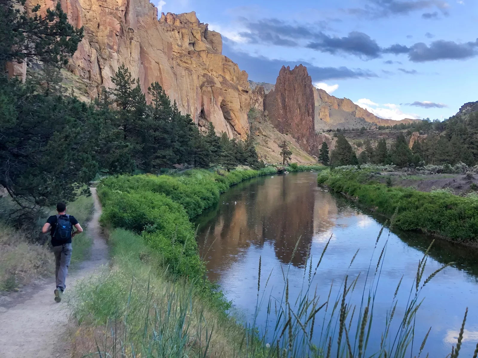 Guest running by small river in Smith Rock Park.