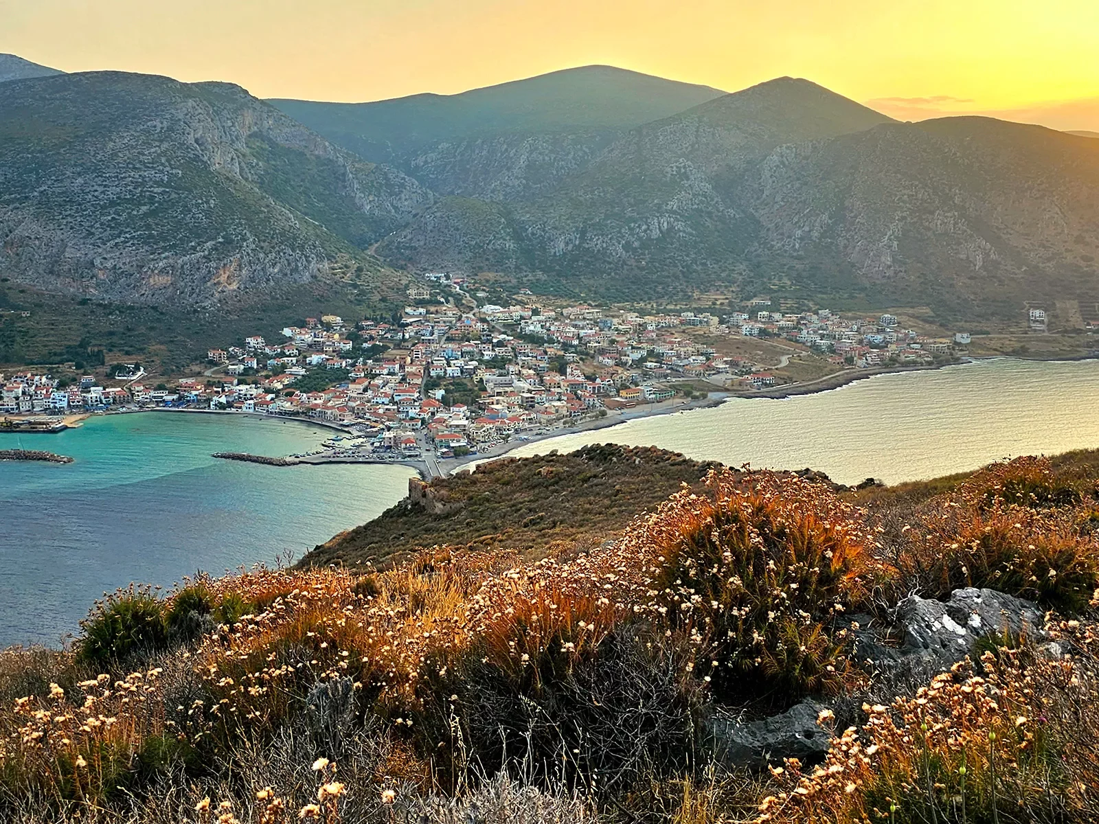 Wide shot of coastal Mediterranean town during sunset.