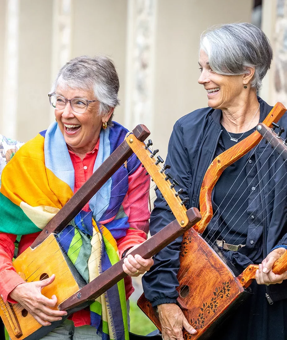 Two women playing Greek instruments.