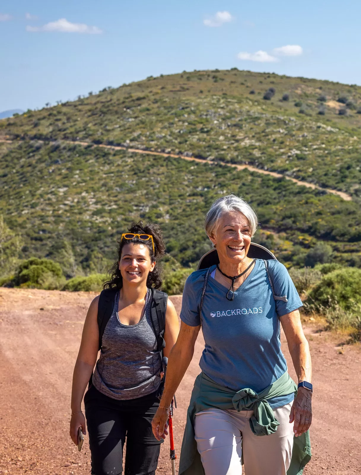 Two hikers on a trail in Greece.