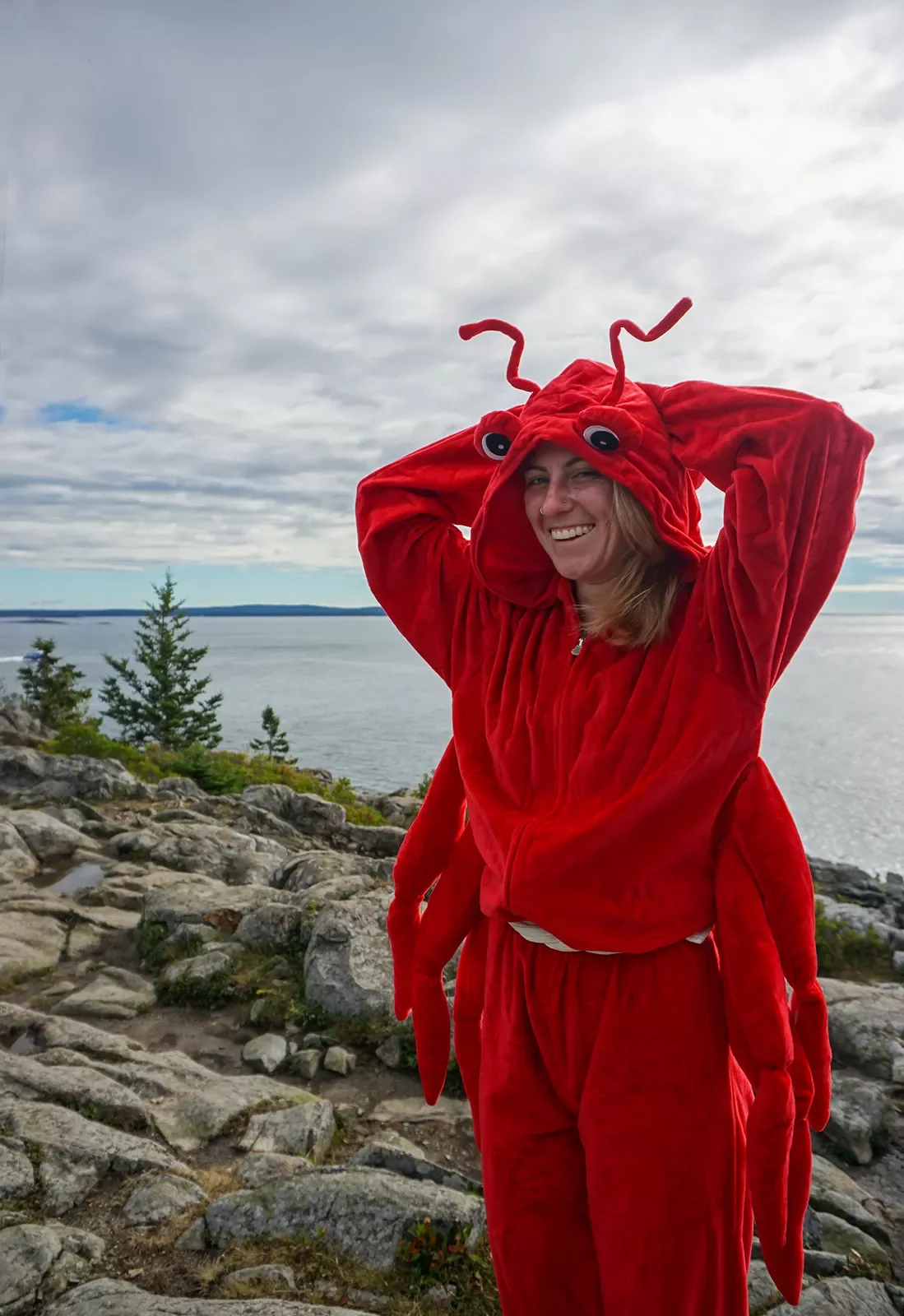 Guest/leader in lobster costume, large lake/ocean in background.