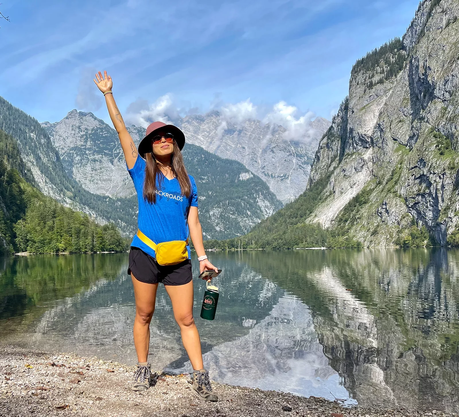 Hiker posing in front of lake in Bavaria.