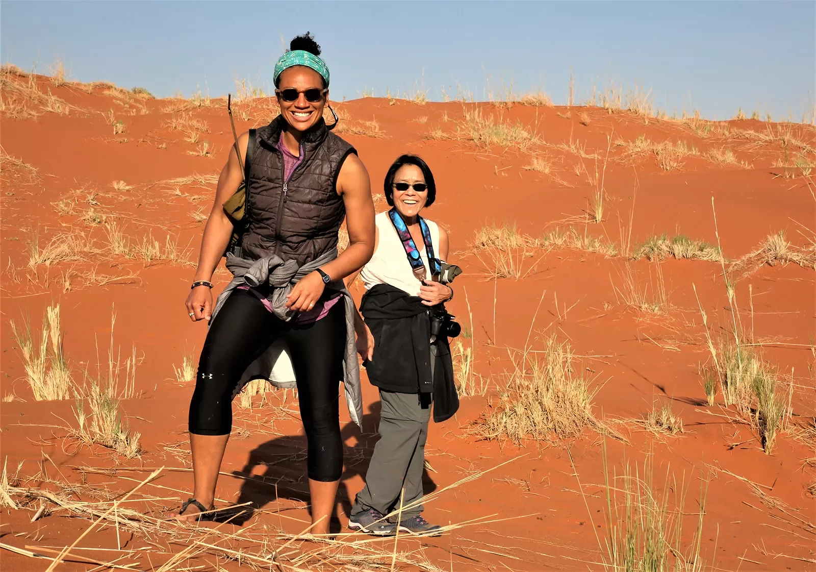 2 women standing in the dunes of Africa