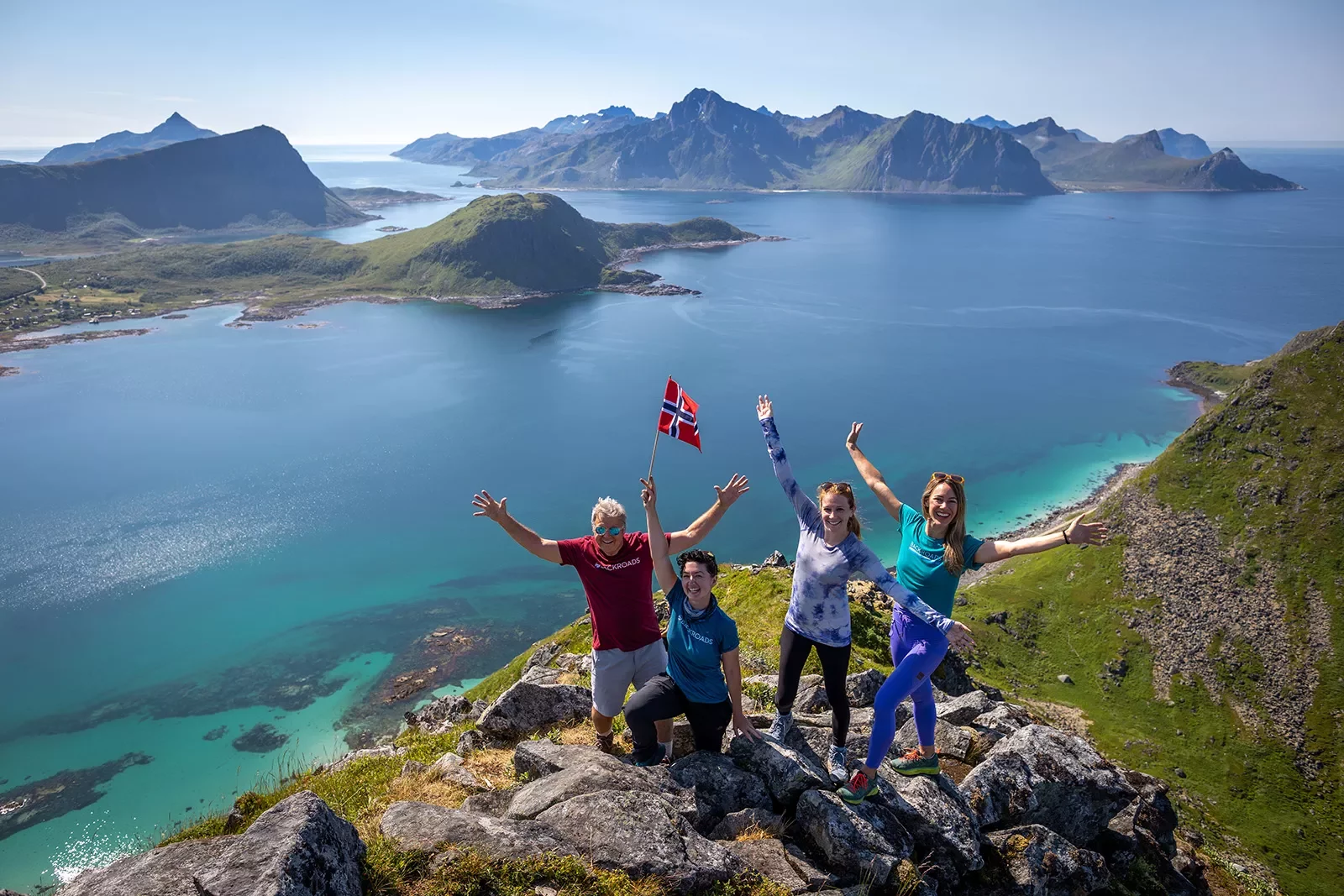Aerial Guests with Norwegian Flag Above Fjord Norway