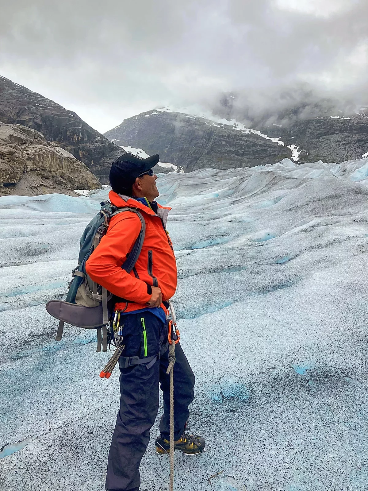 Solo hiker gazing out on a glacier