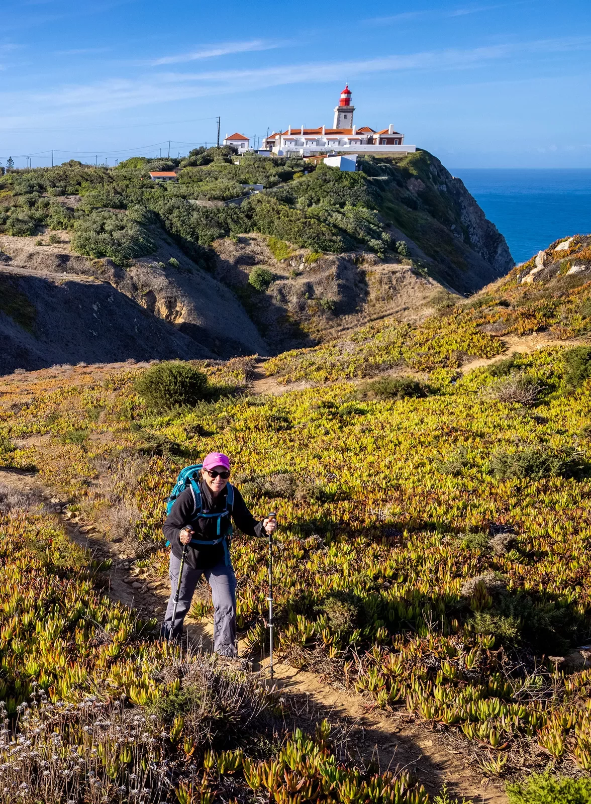 One woman hiking along cliffs