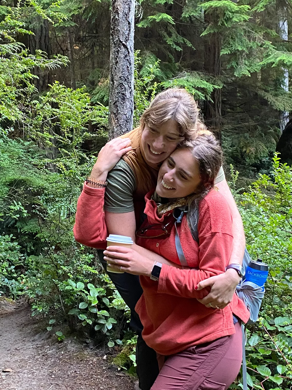 People hugging in the wilderness