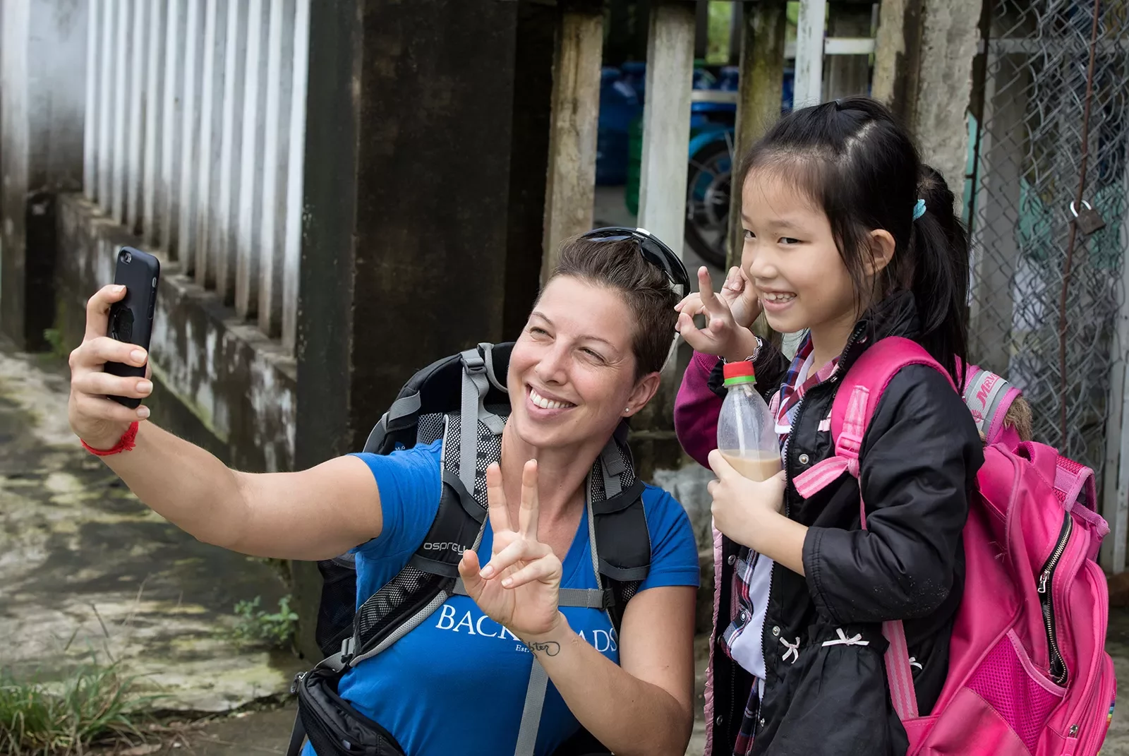 Woman posing and smiling with a child in Vietnam