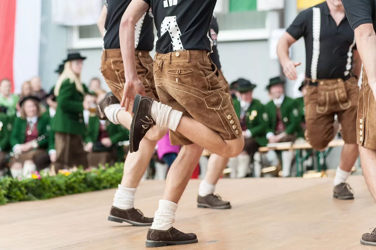 Young men doing an Austrian traditional folk dance.