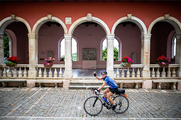 cyclist riding by columns