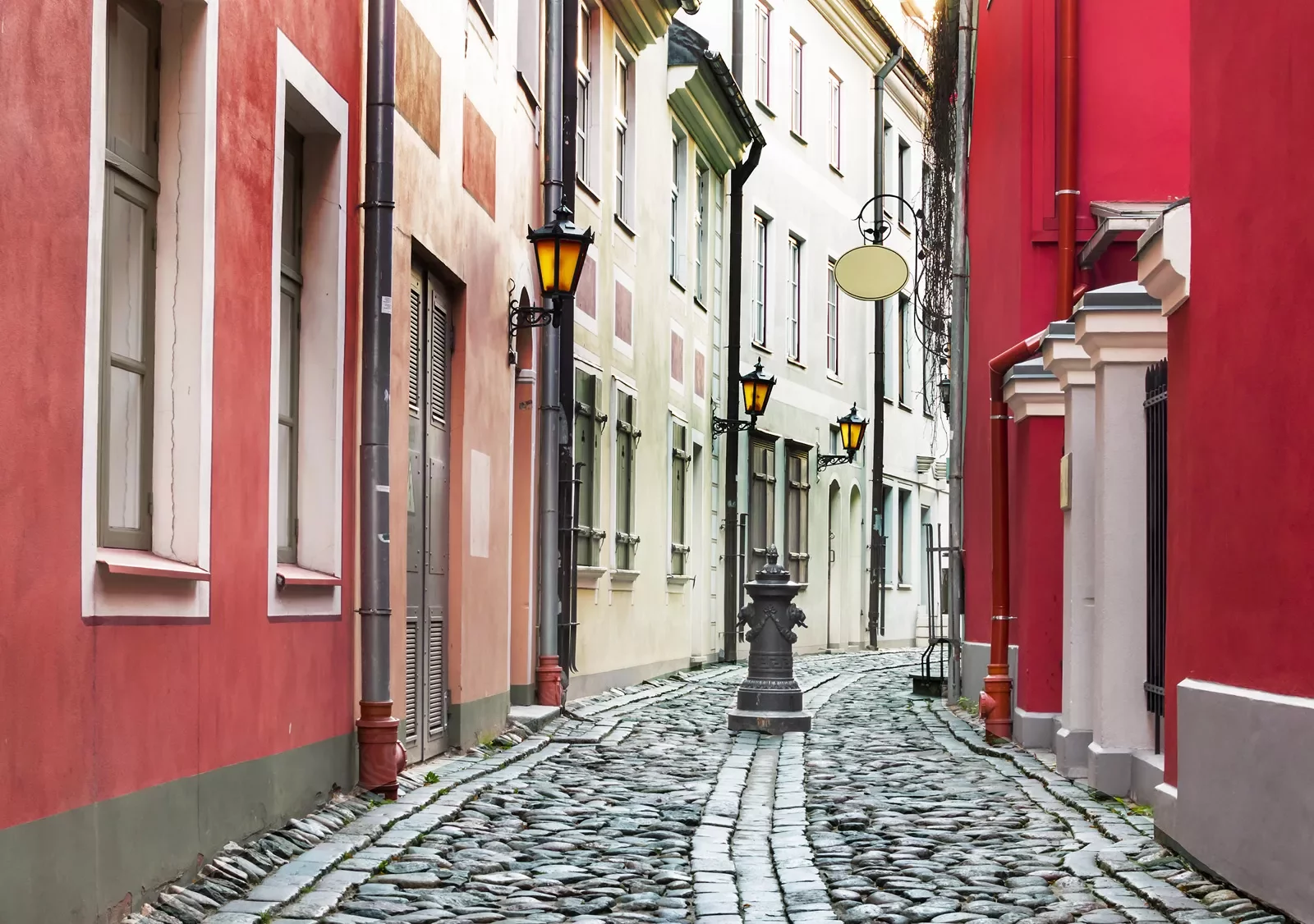 Cobblestone street surrounded by red buildings