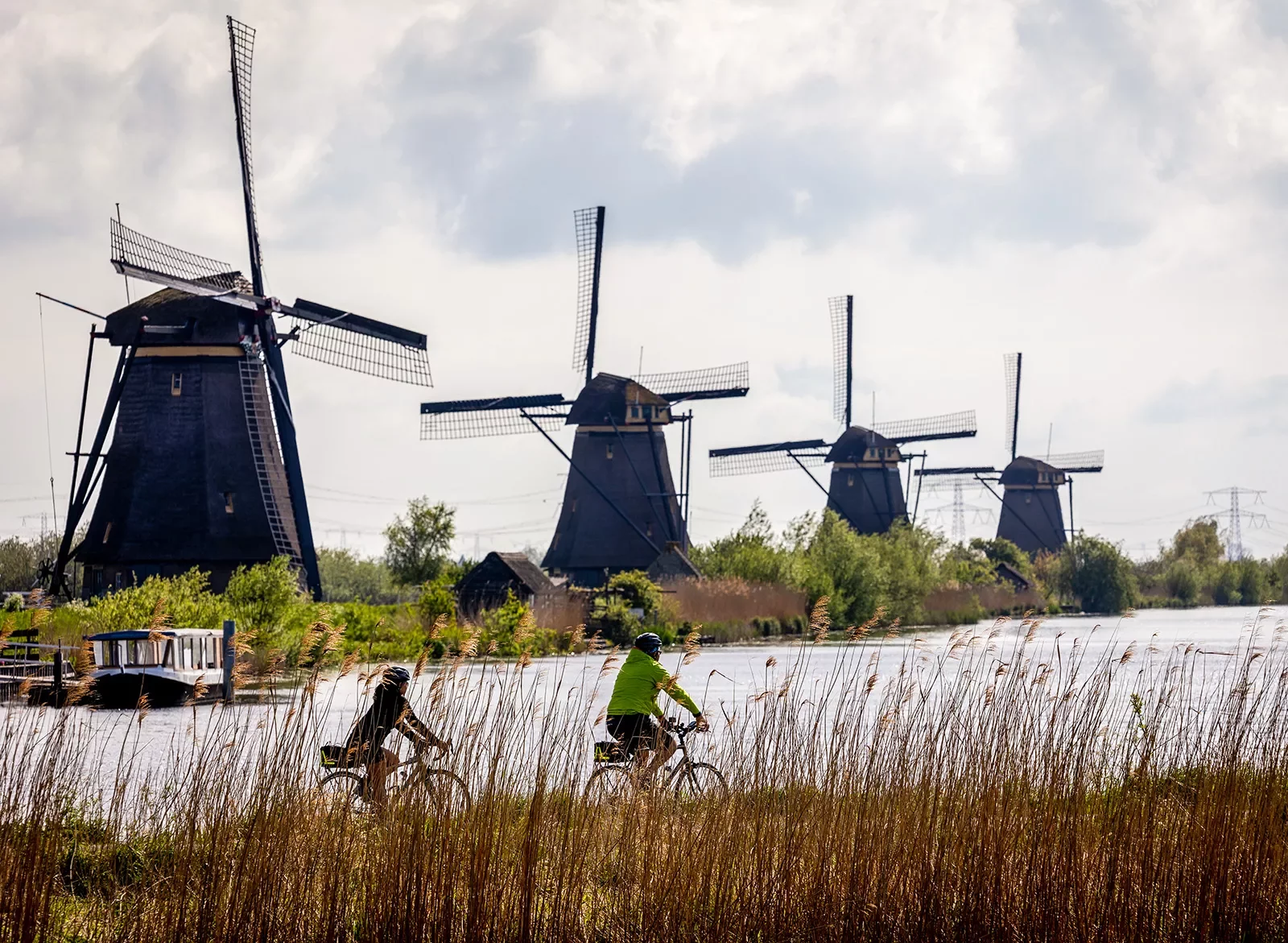 Two bikers in front of windmills