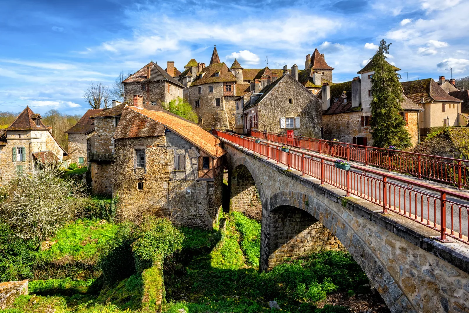 stone bridge with stone buildings in the back