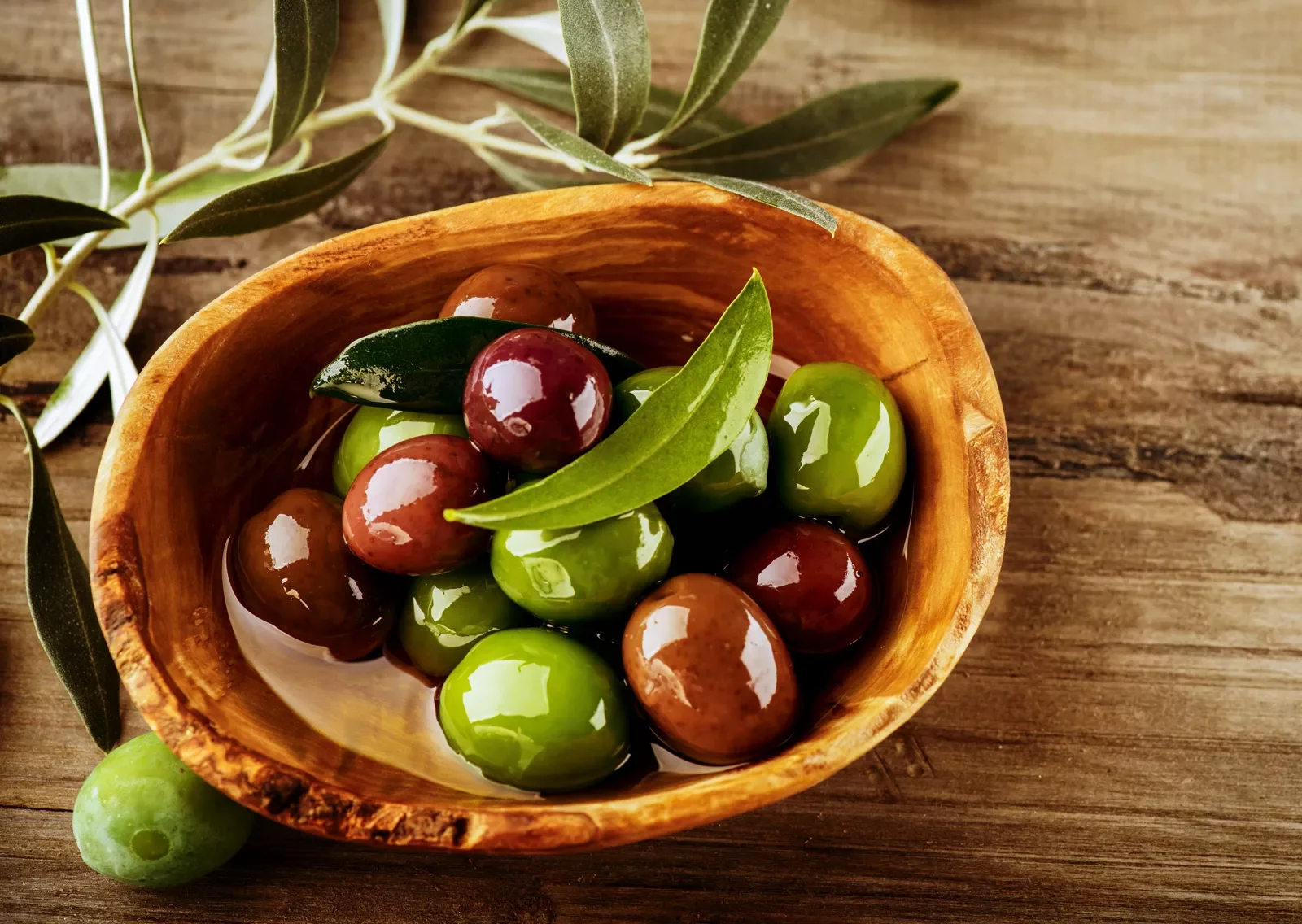 wooden bowl of olives