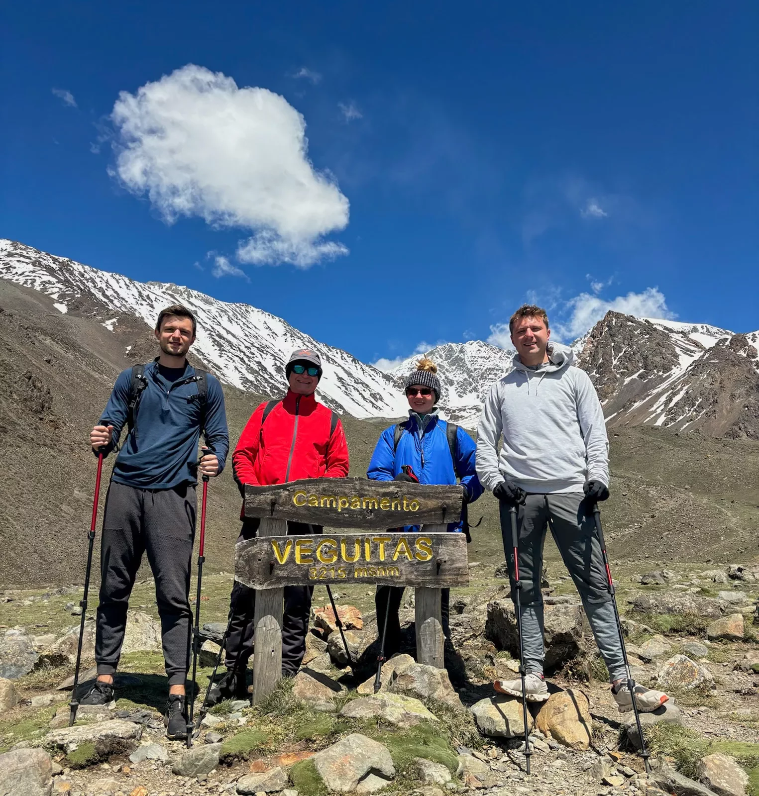 hikers pose with a sign