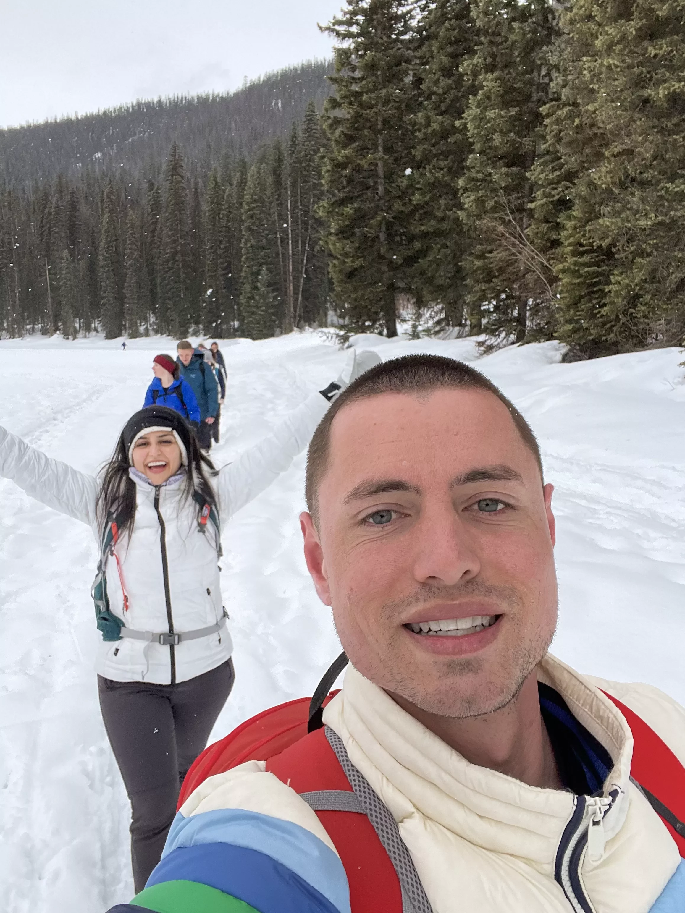 Two people take a selfie while snowshoeing in the snow