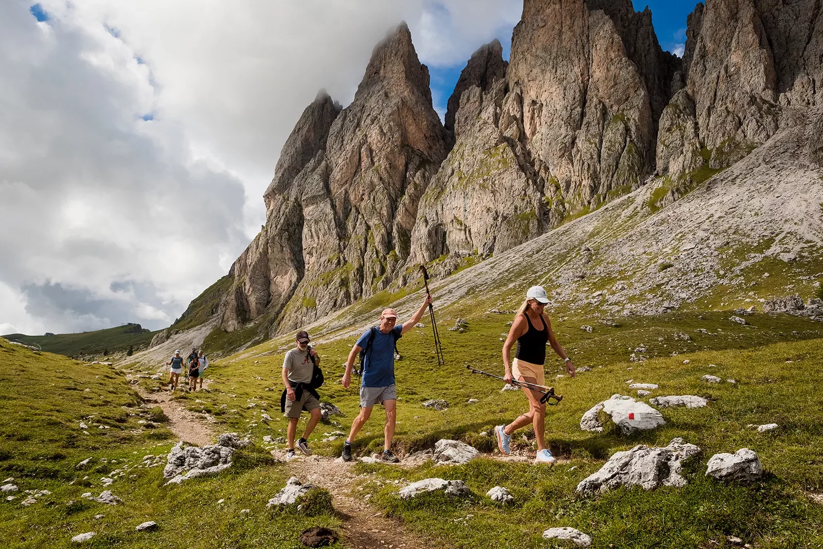 Hikers walking up a path near mountains