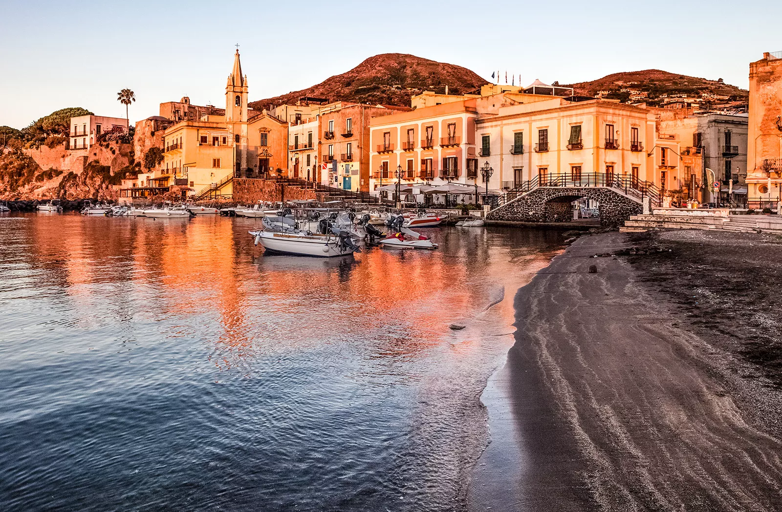 Port filled with multiple boats during sunset time