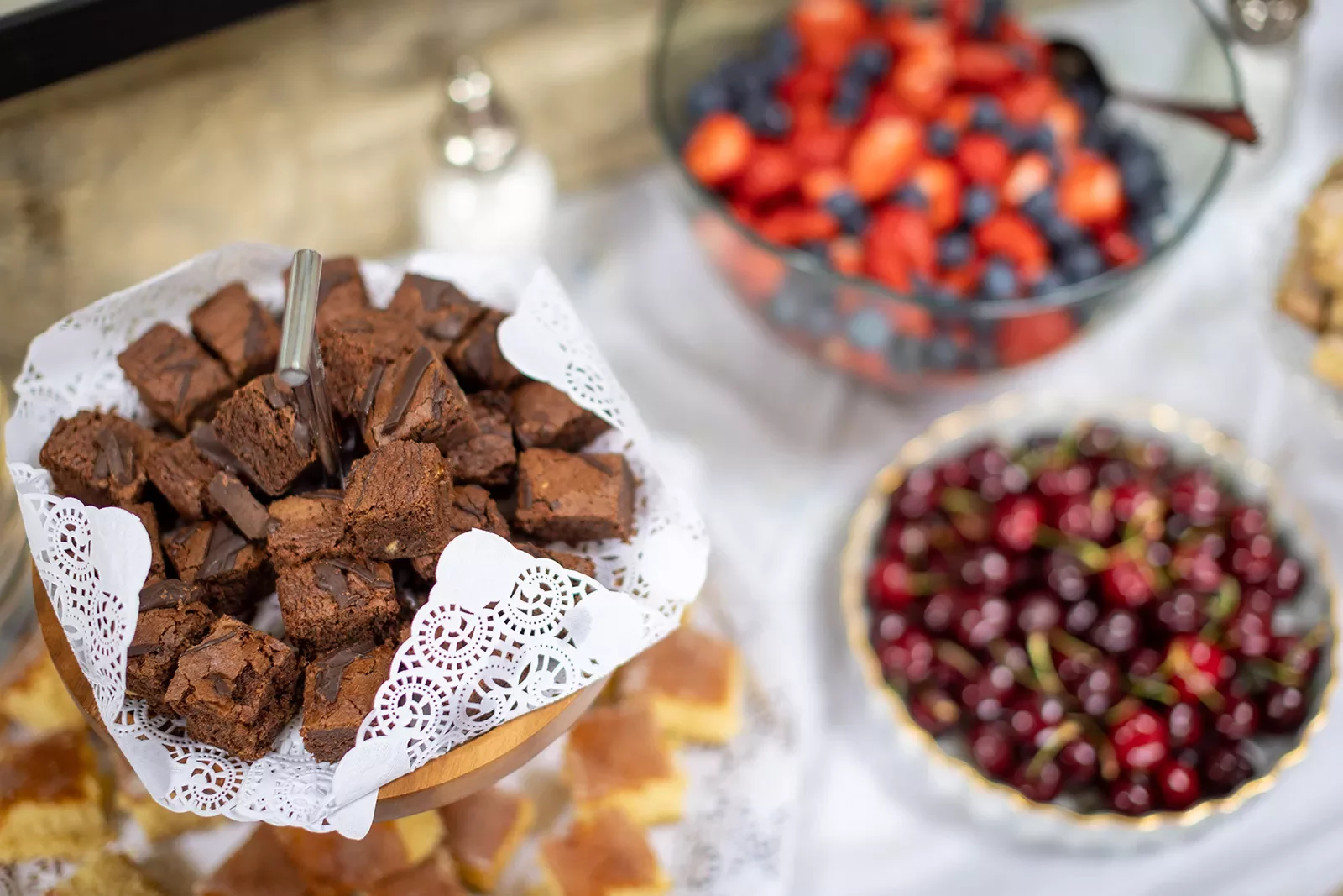 Display of fruit, berries and small brownie bites.