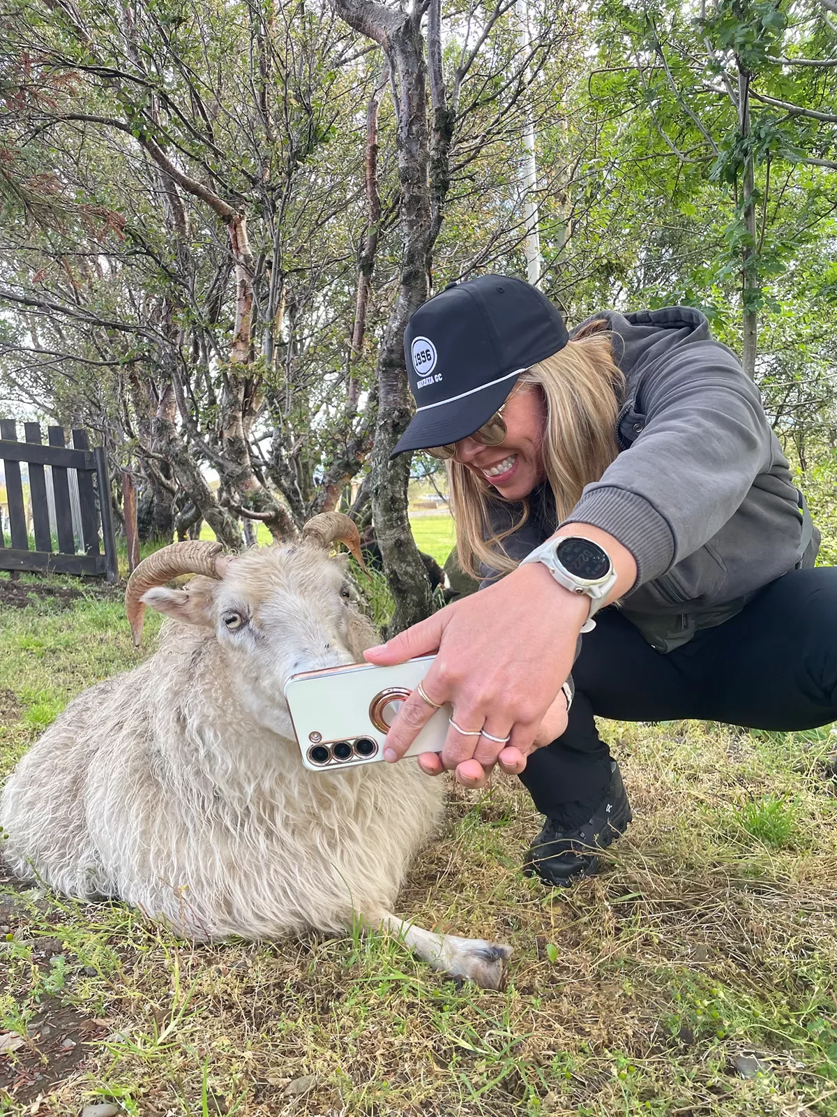 Woman taking a selfie with a goat