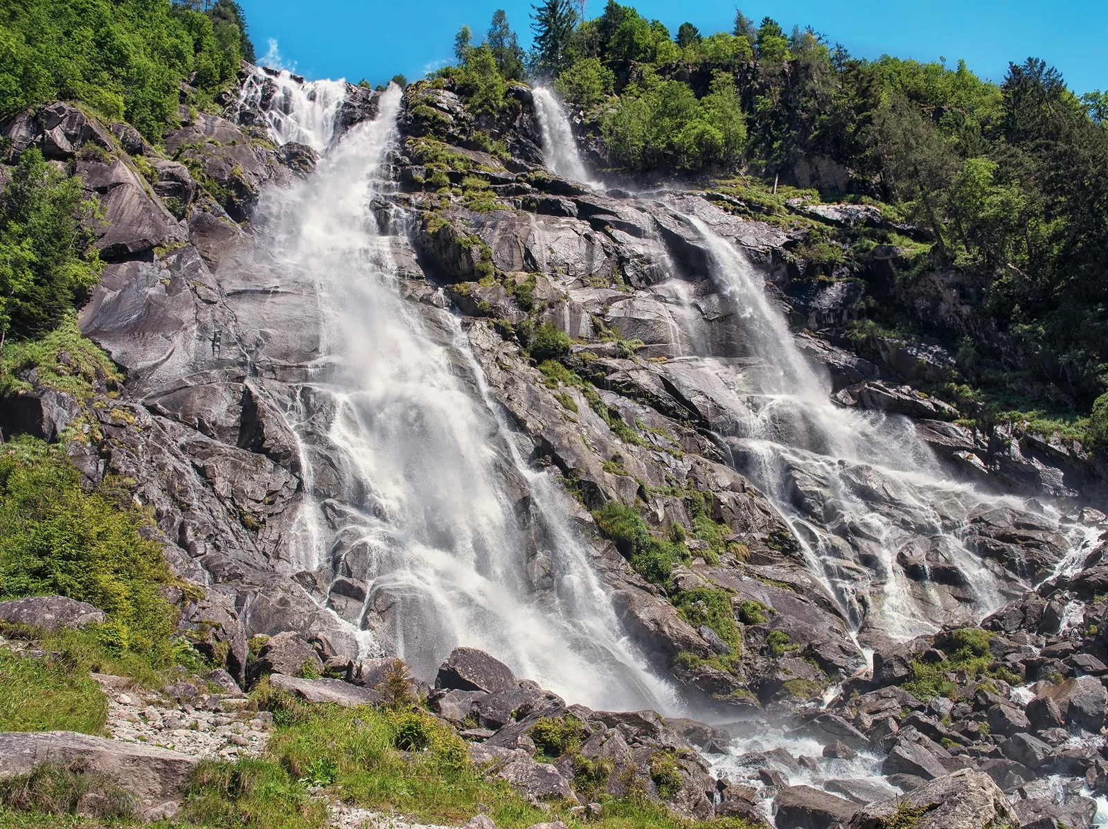 Large cliff with an active waterfall