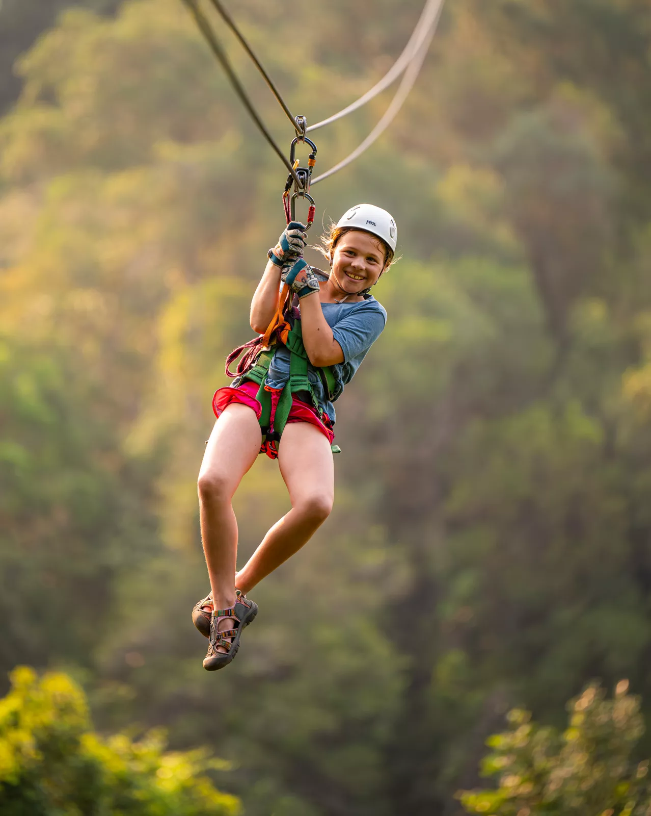 Girl smiling while riding on a zip line