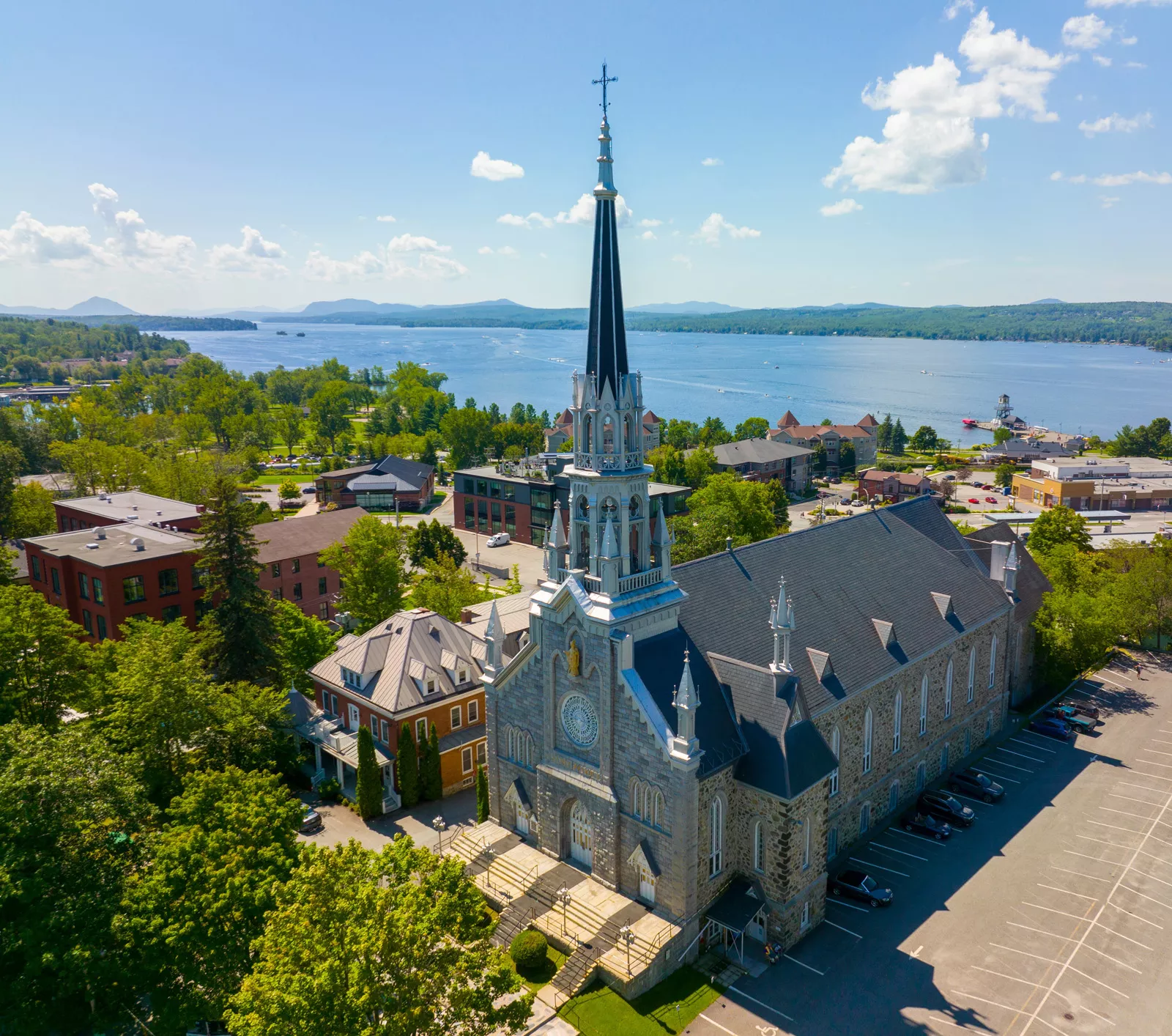 Large gray church building with a large lake in the distance
