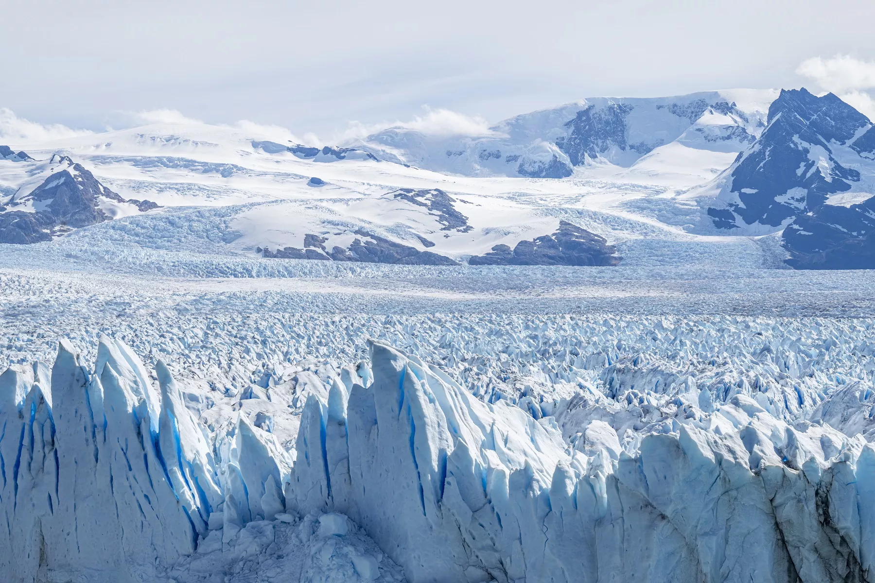 Snow caps and glaciers with mountains in the distance