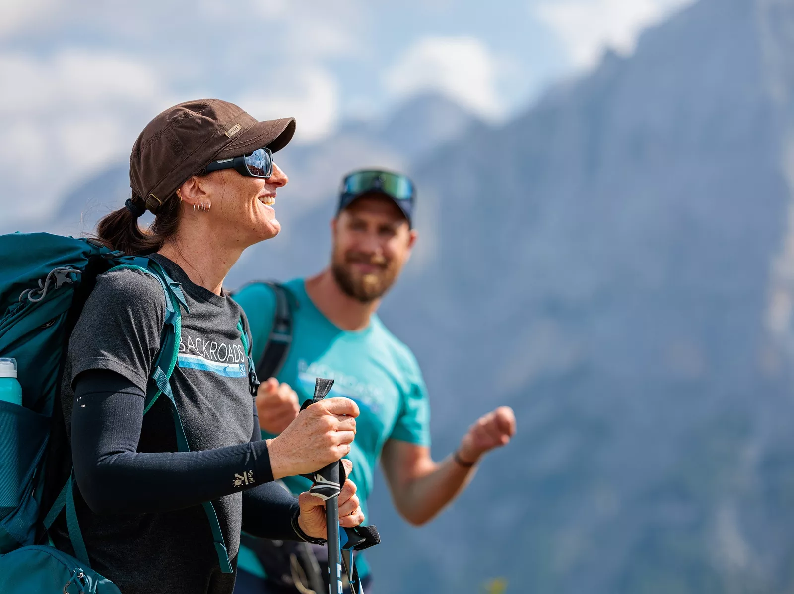 Woman smiling while walking with hiking poles