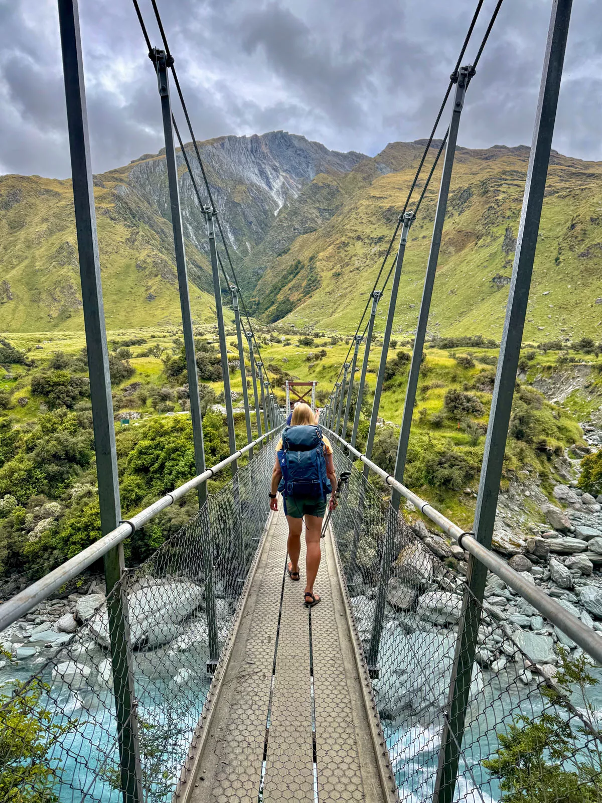 Woman walking on a wooden bridge over a river