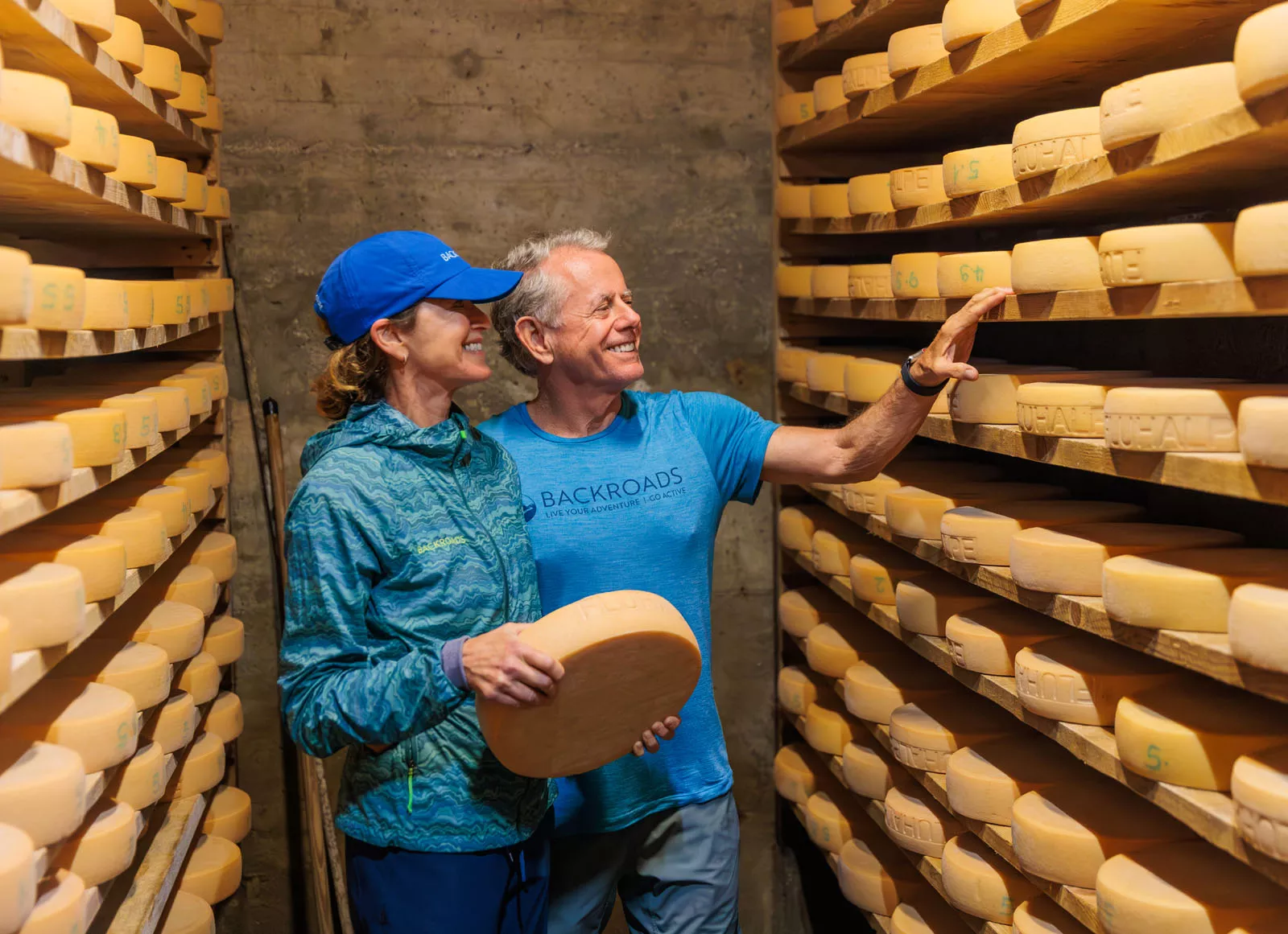Backroads guests looking at wheels of cheese