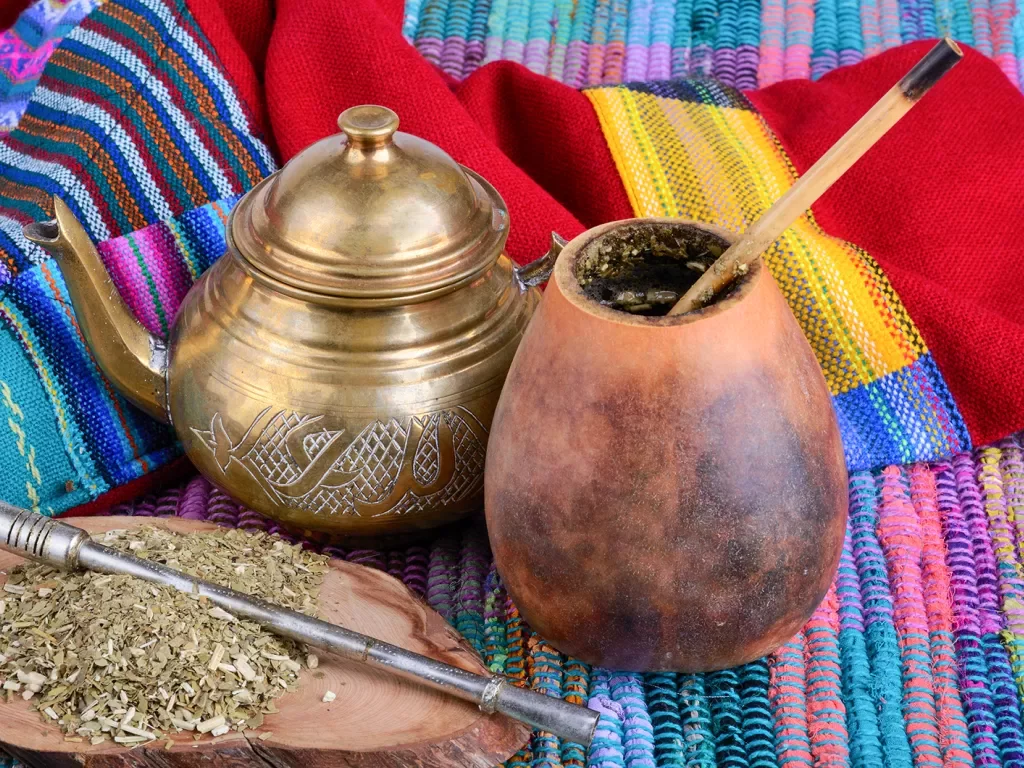 Cup from calabash and teapot with dry mate leaves.Traditional drink of Peru, Brazil and Argentina.
