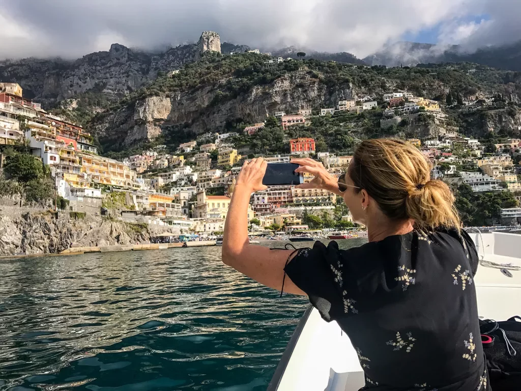 Wide shot of Positano, Amalfi Coast. Guest taking photo in foreground.