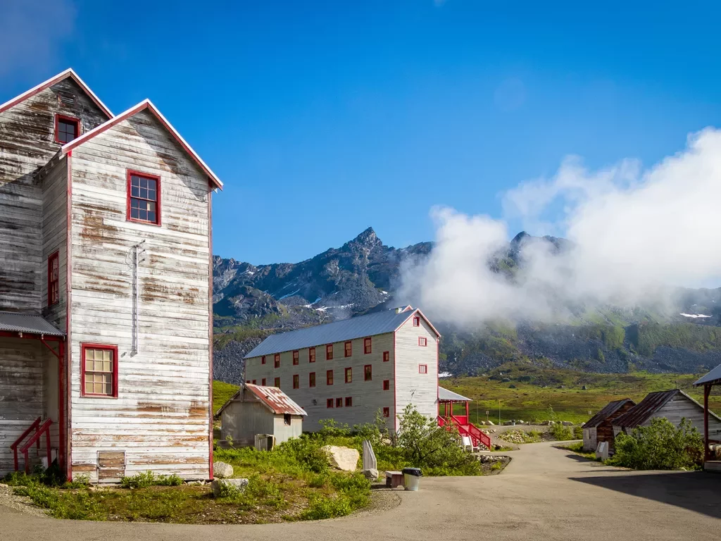 Wood sided buildings next to a mountain in Alaska