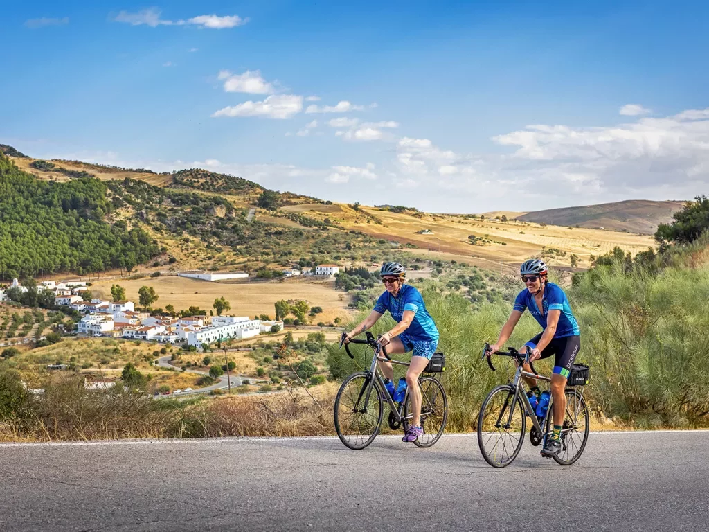 Two bikers riding on a road in southern Spain.