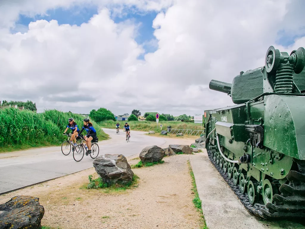 Backroads Guests Biking Past Army Tank