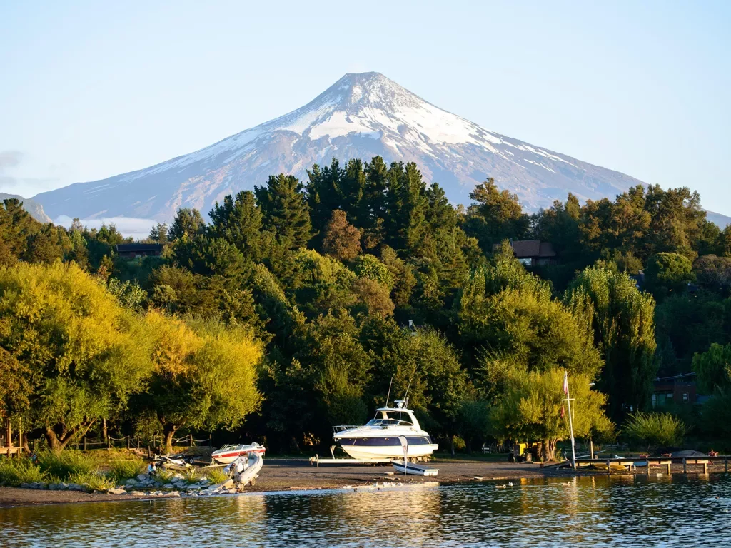 Wide shot of Lago Villarrica, small lake and boat in foreground.