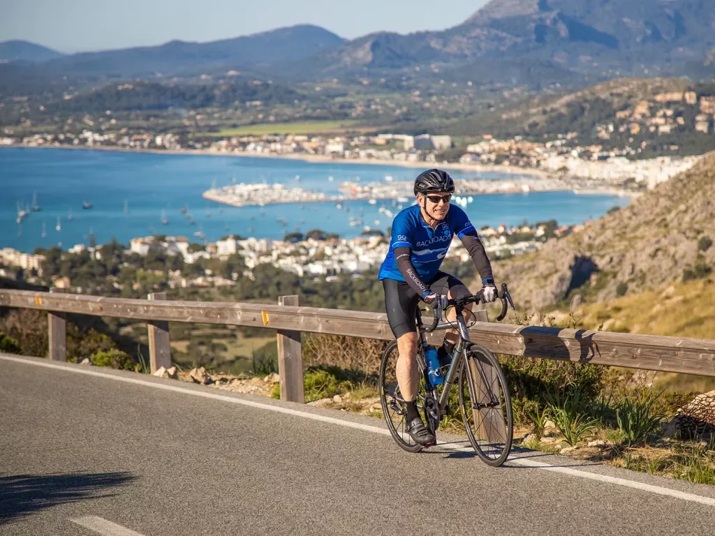 Biker riding along the coast in Menorca.