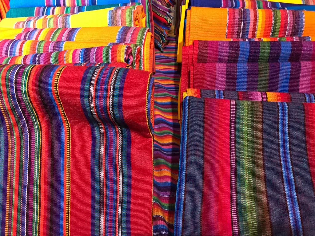 Colorful woven blankets rolled up