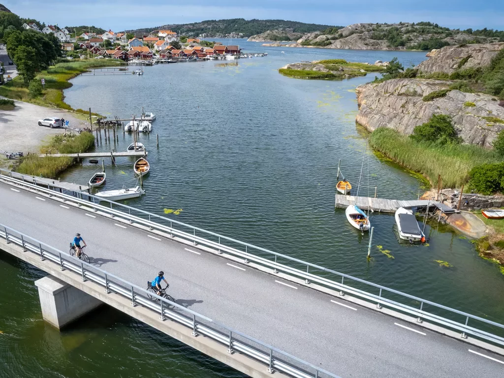 Two bikers riding over a bridge in Norway